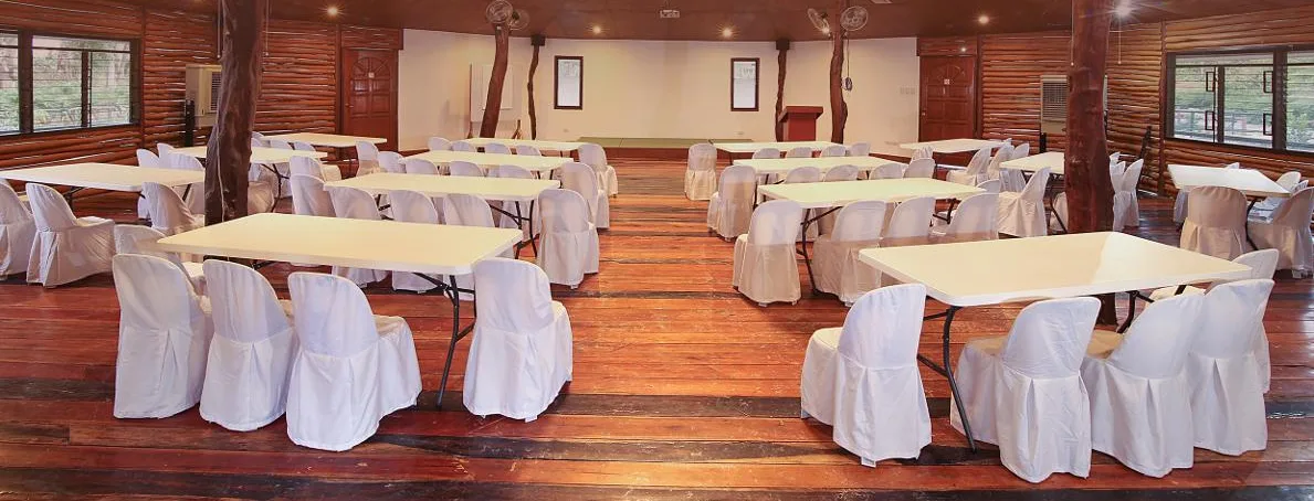 The farm's function hall set with tables and chairs